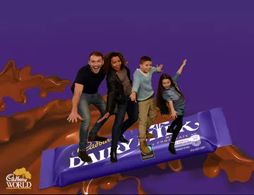 Family green screen standing on top a large Cadbury's chocolate bar at Cadbury World