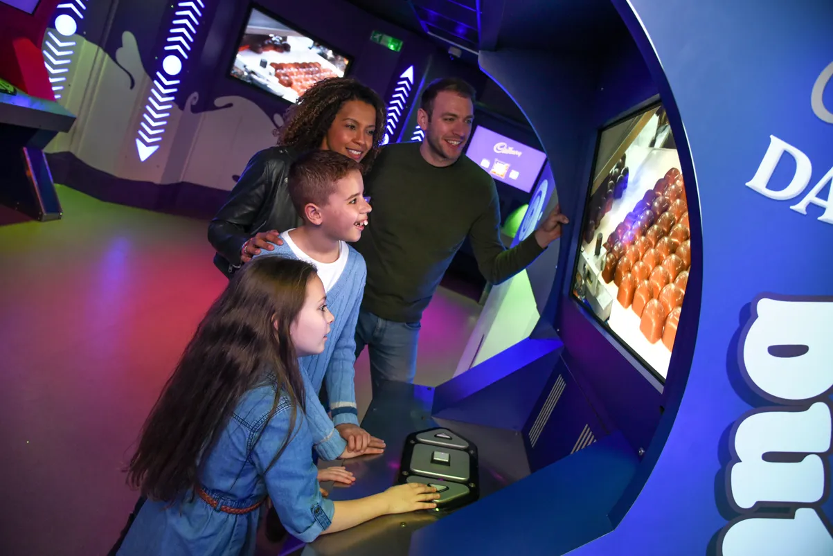 Family watching how Cadbury Buttons are manufactured at Cadbury World