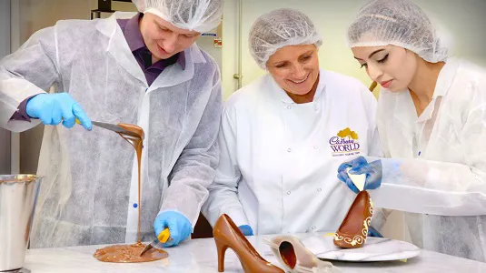 Guests at chocolatier experience creating chocolate shoes at Cadbury World