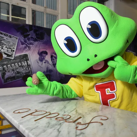 Freddo piping his name with chocolate at Cadbury World