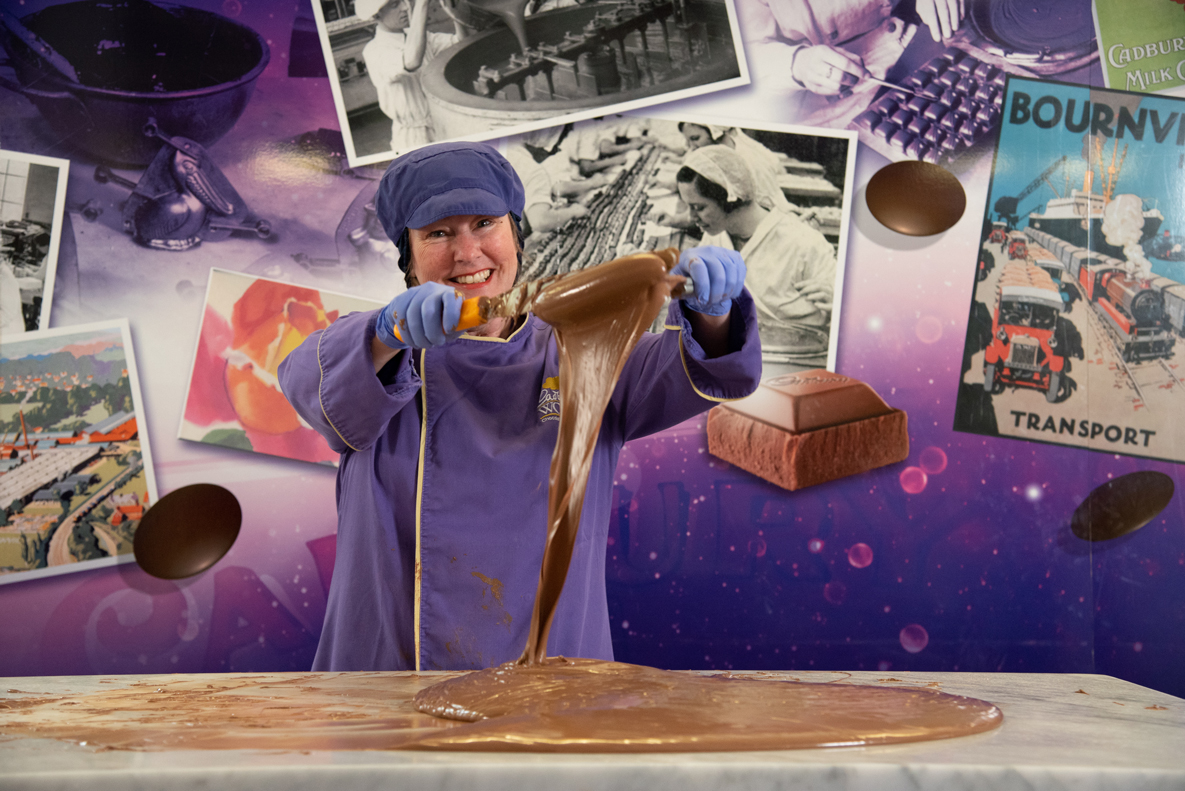 Chocolatier pulling melted chocolate at Cadbury World, Birmingham UK